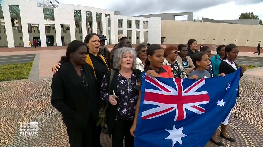 Voice supporters outside parliament house in Canberra.